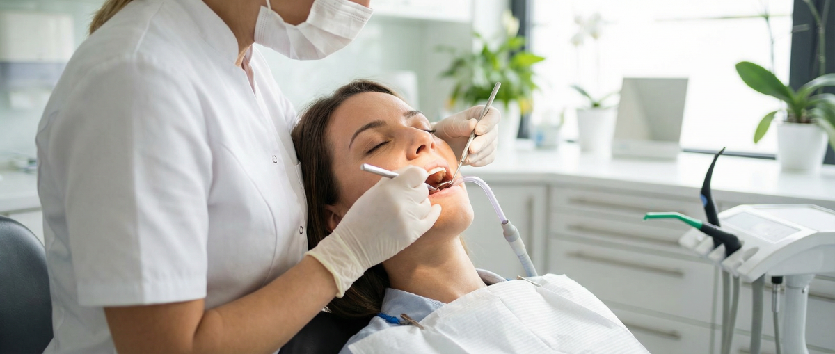Dental hygienist performing scaling and root planing deep cleaning on a patient at North Star Dentistry in Mississauga using ultrasonic instruments for gum disease treatment