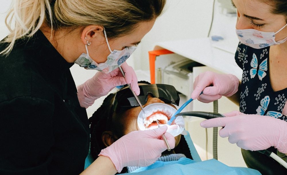 Two registered dental hygienists performing professional teeth cleaning and ultrasonic scaling on a patient at North Star Dentistry in Mississauga